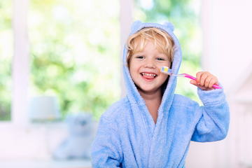 A kid brushing their teeth