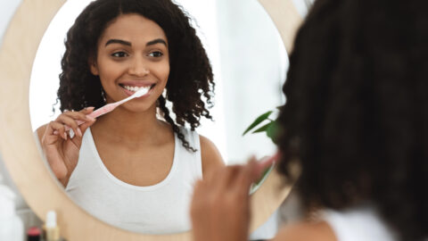woman brushing her teeth
