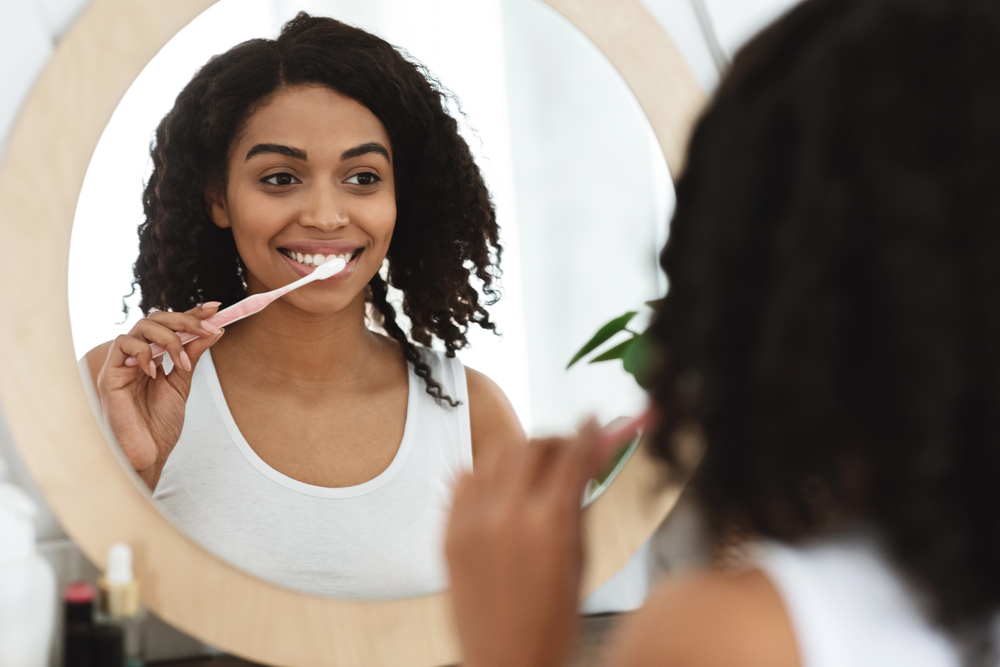 woman brushing her teeth